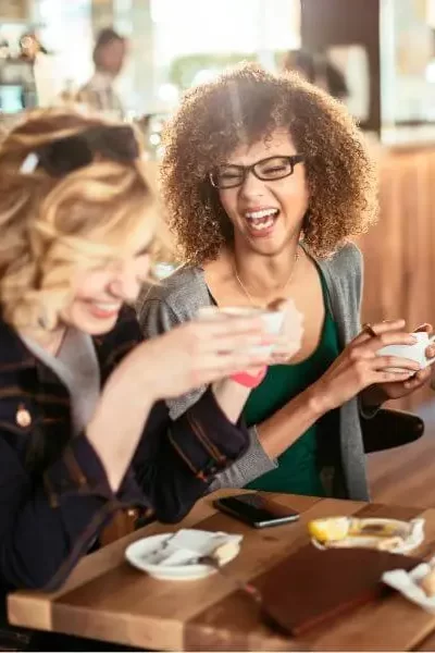 Friends enjoying coffee while Kid breukelen Realty Group Management Group